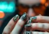 Nail Art for Men: Bold Designs to Rock This Season Masculine hands with metallic guitar-pick nails and holographic question marks.