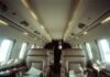 Top 7 Luxury Travel Companies That Redefine First-Class Vacations Luxurious private jet interior with champagne and maps.