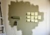 DIY Home Renovation Tips That Save You Thousands Without Hiring a Pro Half-painted wall with tools and spills.
