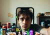 The Best Funny Memes of 2025: A Collection That Will Make You LOL Chaotic desk selfie with glitchy meme collage and smirk